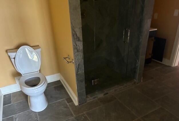 bathroom with toilet and walk in shower