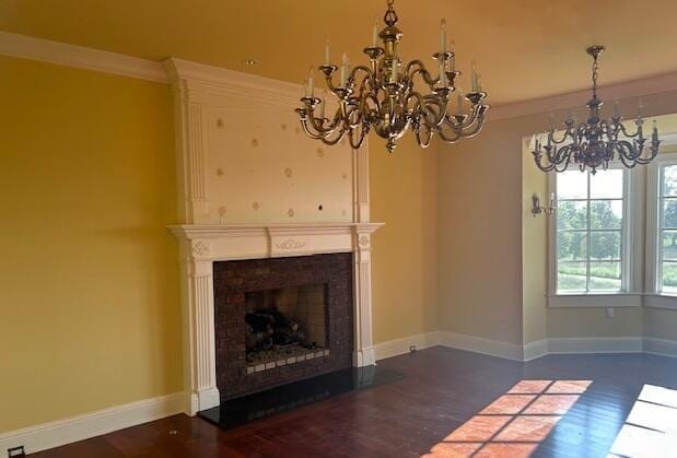 unfurnished living room featuring dark wood-type flooring and ornamental molding