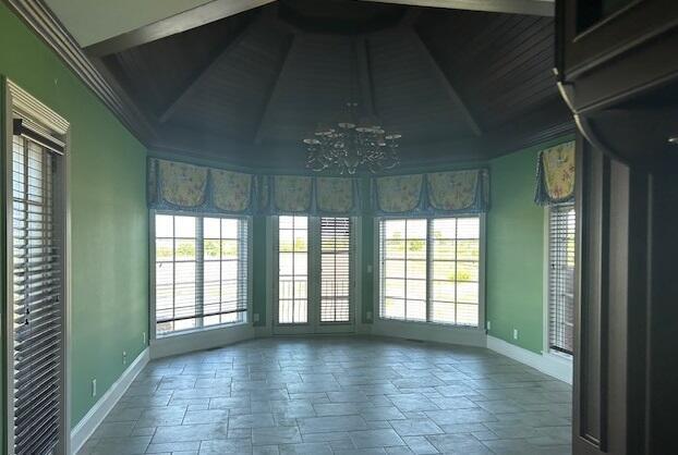 unfurnished sunroom with a chandelier and lofted ceiling