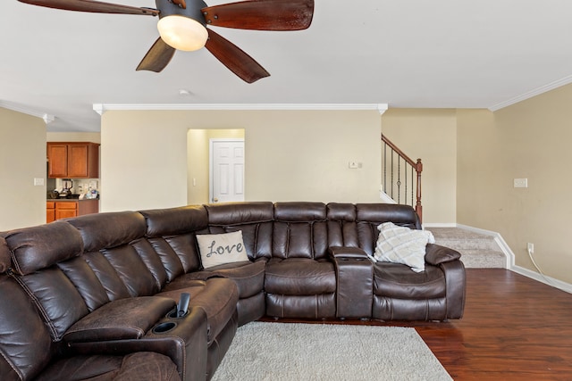 living room featuring dark hardwood / wood-style floors, ceiling fan, and crown molding