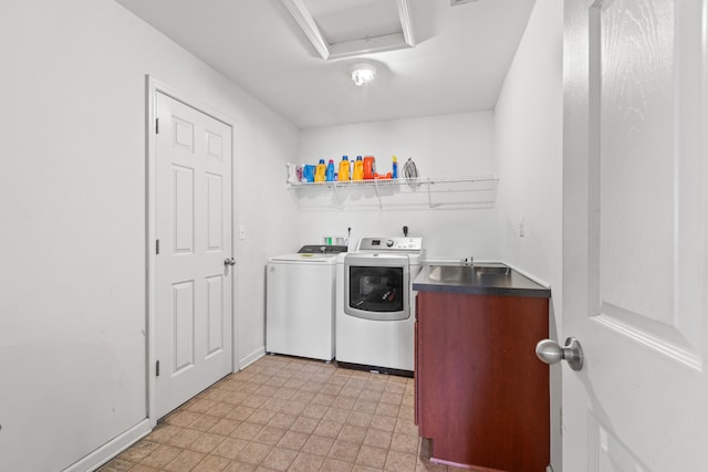 clothes washing area featuring independent washer and dryer and sink