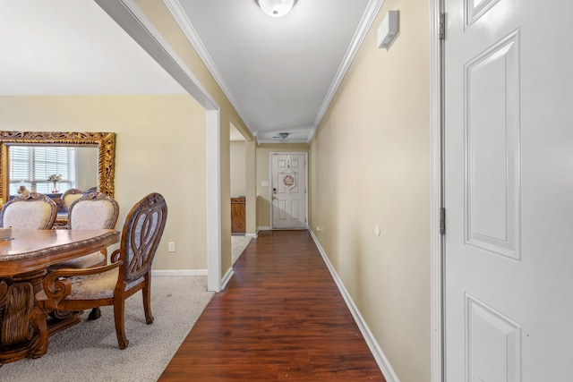 hall featuring dark wood-type flooring and ornamental molding