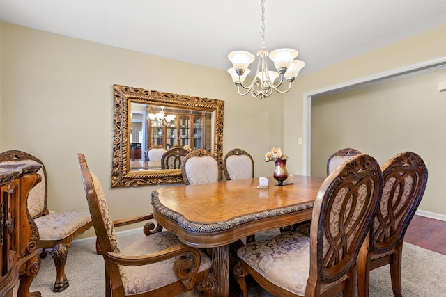 carpeted dining area featuring a notable chandelier