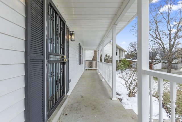 view of snow covered back of property