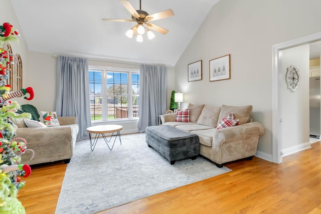 living room with ceiling fan, high vaulted ceiling, and wood-type flooring