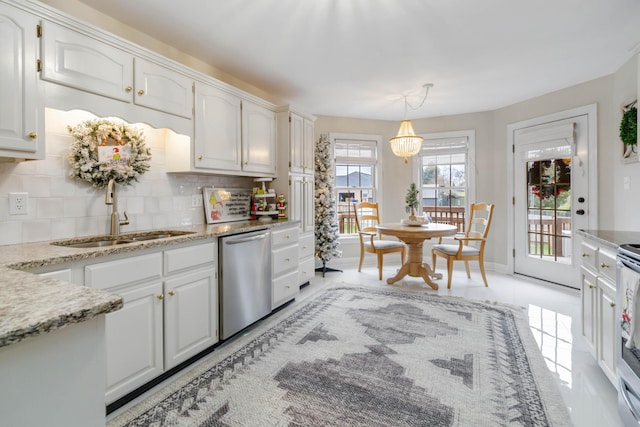 kitchen featuring decorative backsplash, light tile patterned floors, pendant lighting, dishwasher, and white cabinetry