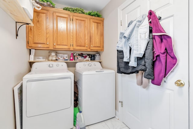 laundry room featuring cabinets and washing machine and dryer