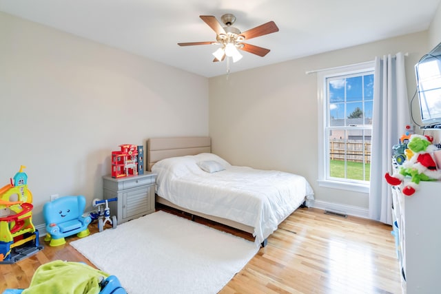 bedroom with ceiling fan and light wood-type flooring