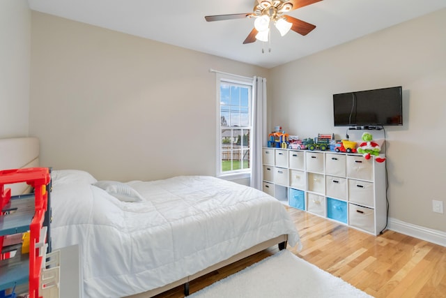 bedroom featuring hardwood / wood-style floors and ceiling fan