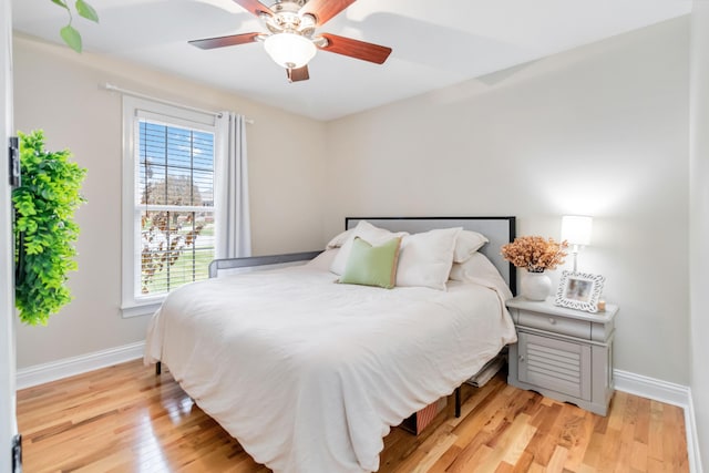 bedroom with hardwood / wood-style flooring and ceiling fan