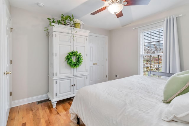 bedroom featuring ceiling fan, vaulted ceiling, and light hardwood / wood-style flooring