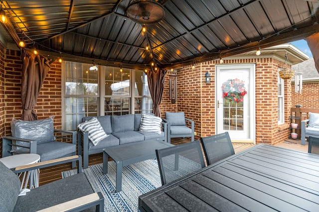 wooden terrace featuring outdoor lounge area and a gazebo