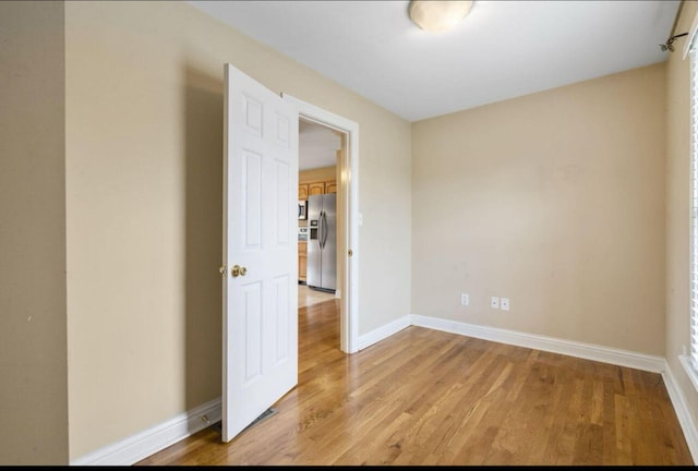 unfurnished room featuring light wood-type flooring