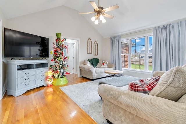 living room featuring ceiling fan, wood-type flooring, and lofted ceiling