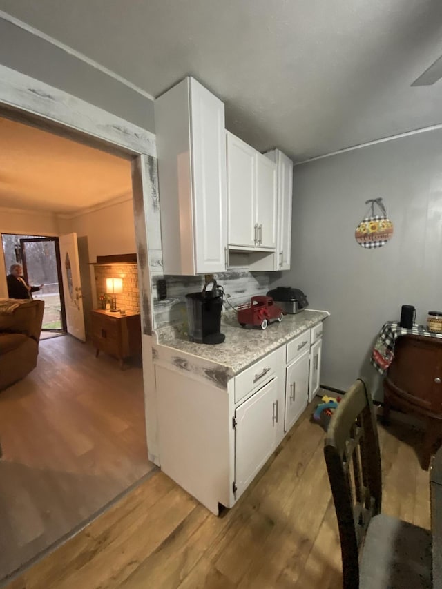 kitchen with white cabinets and light hardwood / wood-style floors