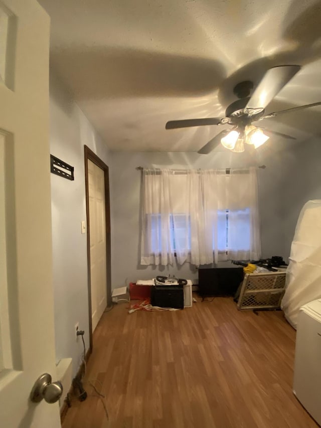 interior space featuring ceiling fan, a healthy amount of sunlight, and wood-type flooring