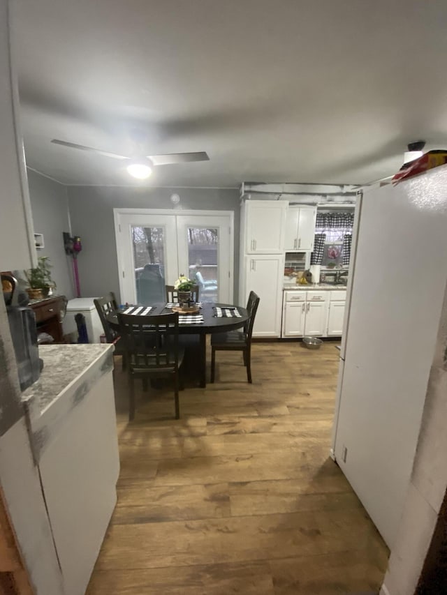 dining room with ceiling fan, hardwood / wood-style floors, and french doors