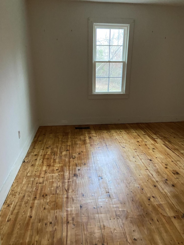 unfurnished room with wood-type flooring and a textured ceiling