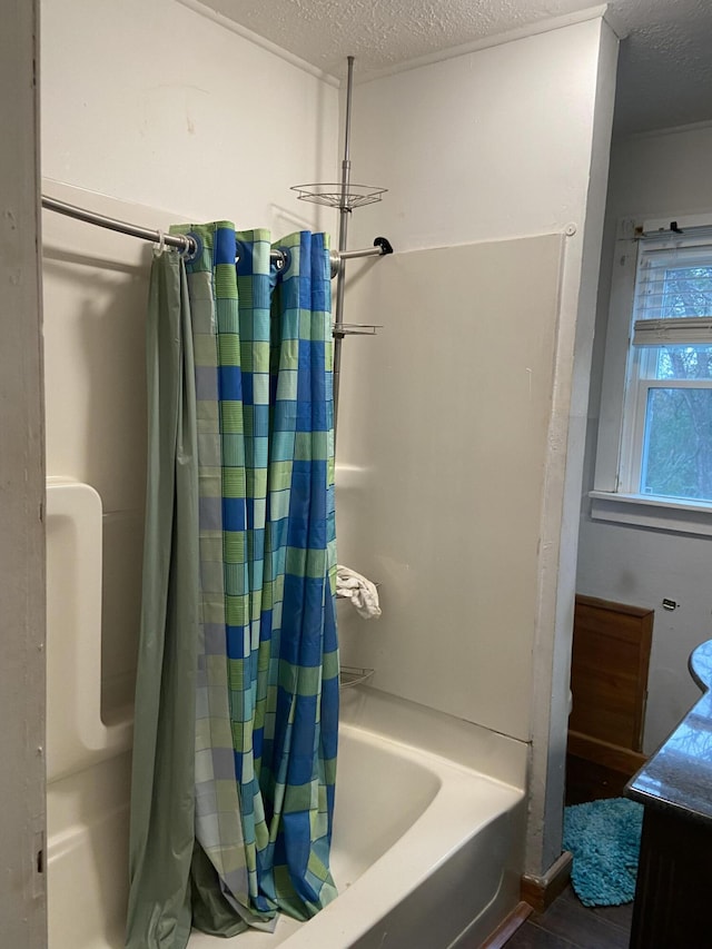 bathroom with vanity, shower / tub combo, a textured ceiling, and wood-type flooring