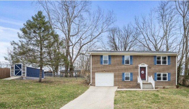 bi-level home with a front yard and a garage