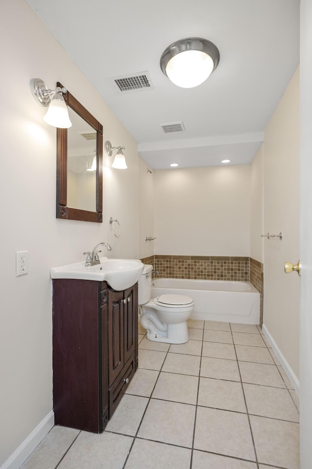 bathroom with visible vents, toilet, a bathing tub, and tile patterned floors