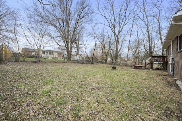 view of yard with a fenced backyard and a wooden deck