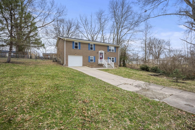 raised ranch featuring an attached garage, brick siding, fence, concrete driveway, and a front yard