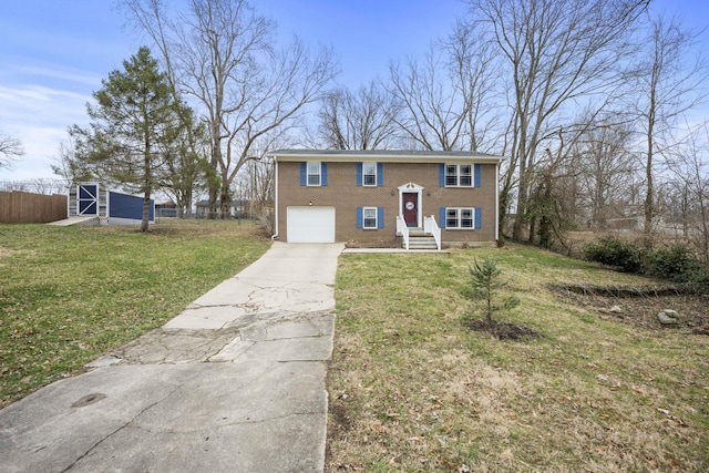 raised ranch with a garage, driveway, a front yard, and brick siding