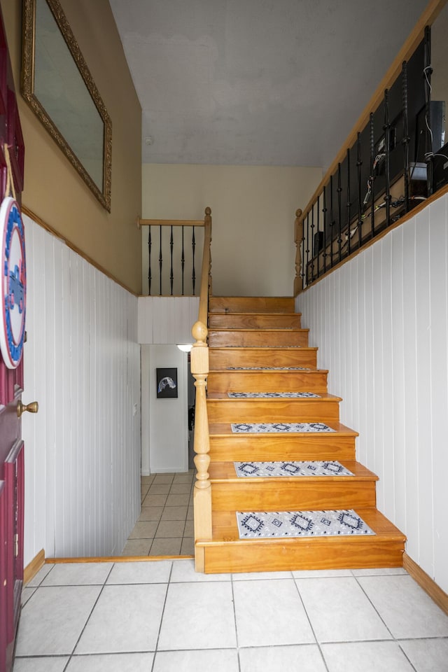 stairs featuring tile patterned floors