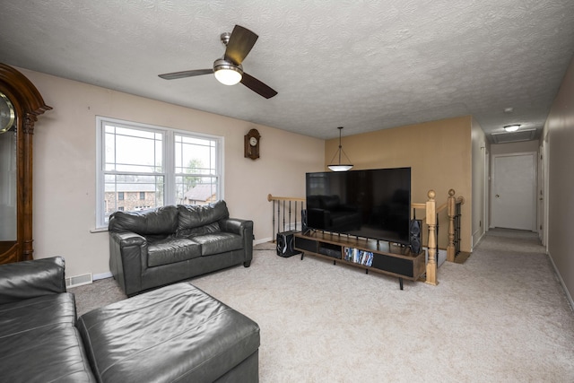 living room featuring carpet flooring, visible vents, and baseboards