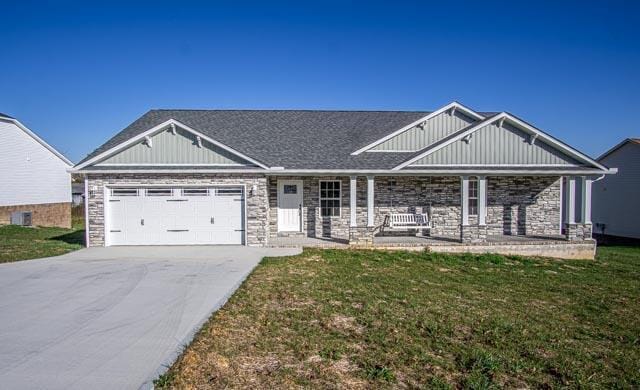 craftsman house featuring a front lawn, a porch, and a garage