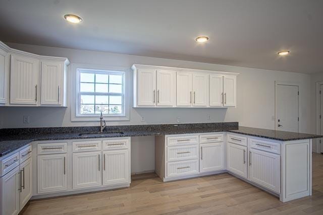 kitchen with white cabinets and light hardwood / wood-style floors