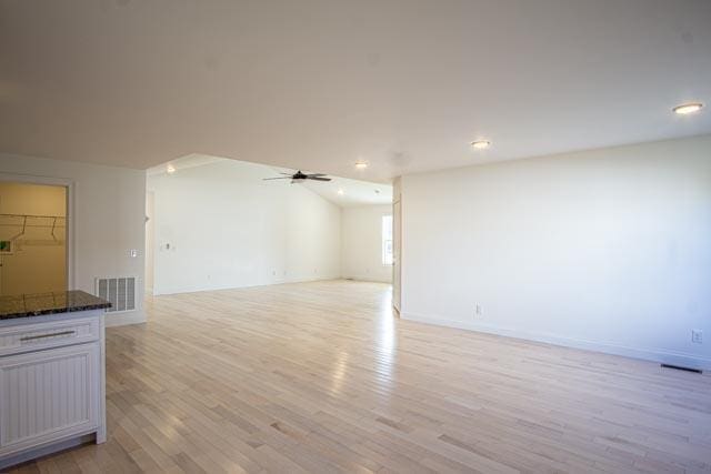 unfurnished living room featuring ceiling fan and light wood-type flooring