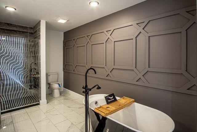 bathroom featuring a tub and toilet