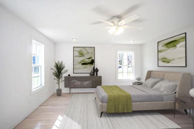 bedroom featuring light wood-type flooring, multiple windows, and ceiling fan