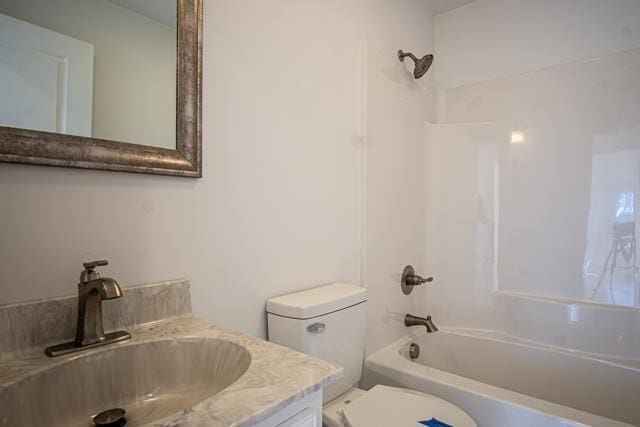 full bathroom with bathing tub / shower combination, vanity, and toilet