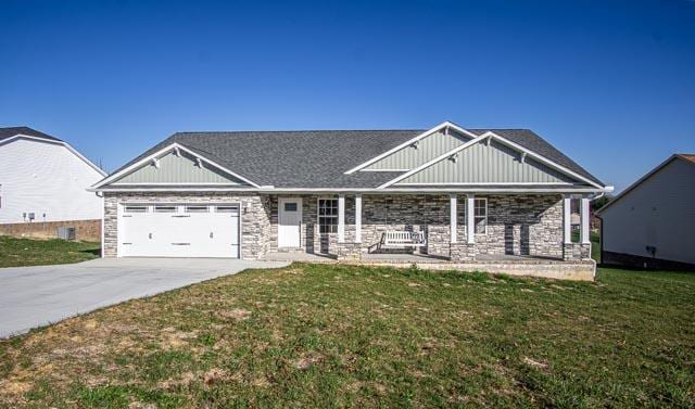 craftsman house with a garage and a front yard