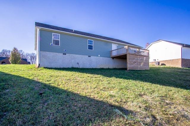 back of house featuring a yard and a deck