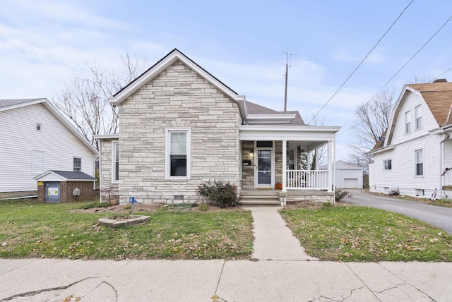 bungalow with a front yard and covered porch