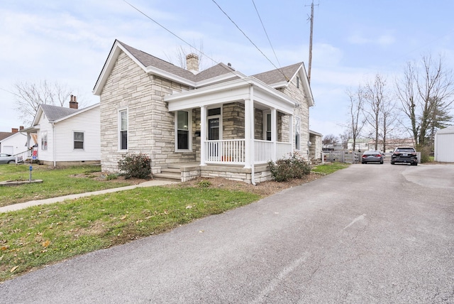 exterior space with a porch and a front lawn