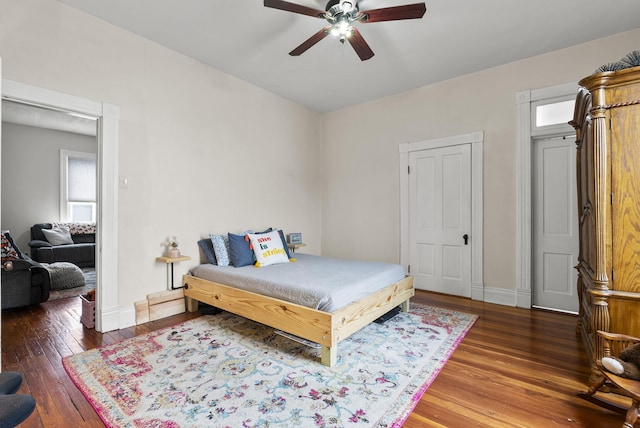 bedroom with ceiling fan and dark hardwood / wood-style flooring