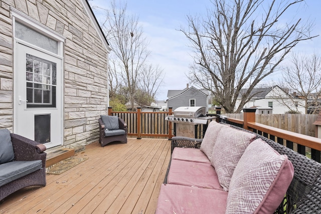 wooden terrace with a grill