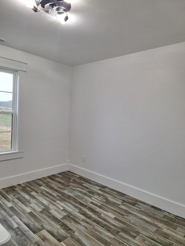 unfurnished room featuring dark hardwood / wood-style flooring