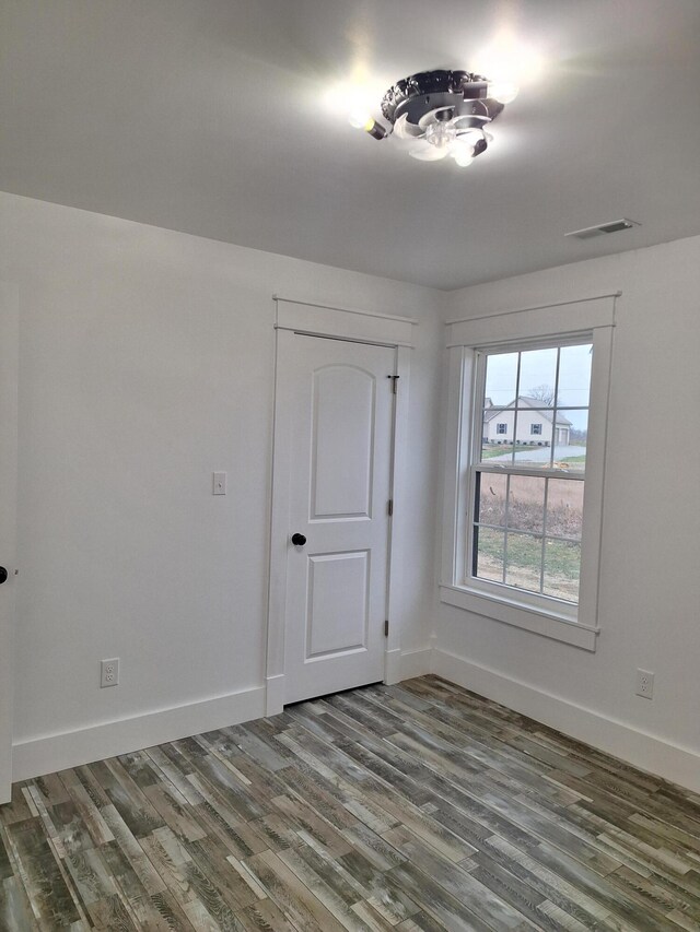 spare room with wood-type flooring