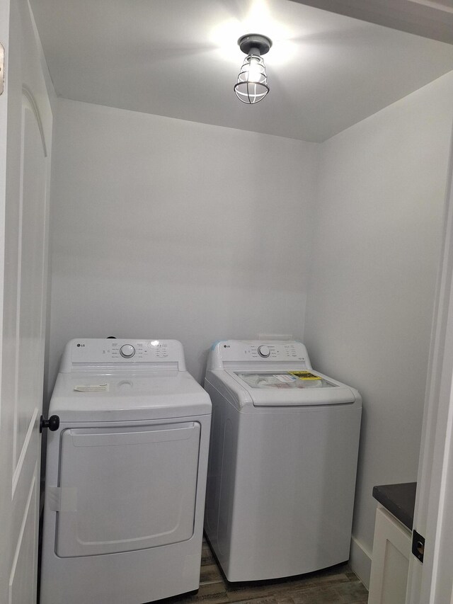 washroom featuring cabinets, dark hardwood / wood-style flooring, and separate washer and dryer