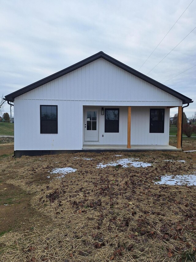 back of house featuring a porch