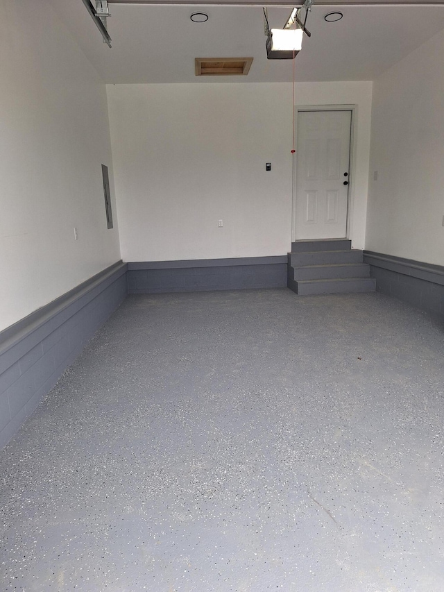 15 David St, Flemingsburg, KY 41041 - garage featuring a garage door opener and wainscoting
