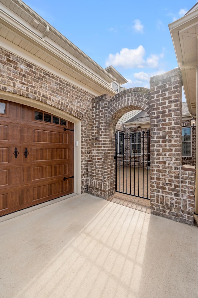 garage featuring concrete driveway