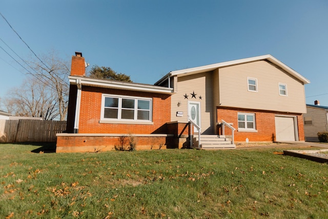 view of front of property featuring a garage and a front yard