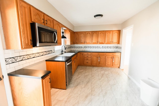 kitchen with appliances with stainless steel finishes, tasteful backsplash, and sink